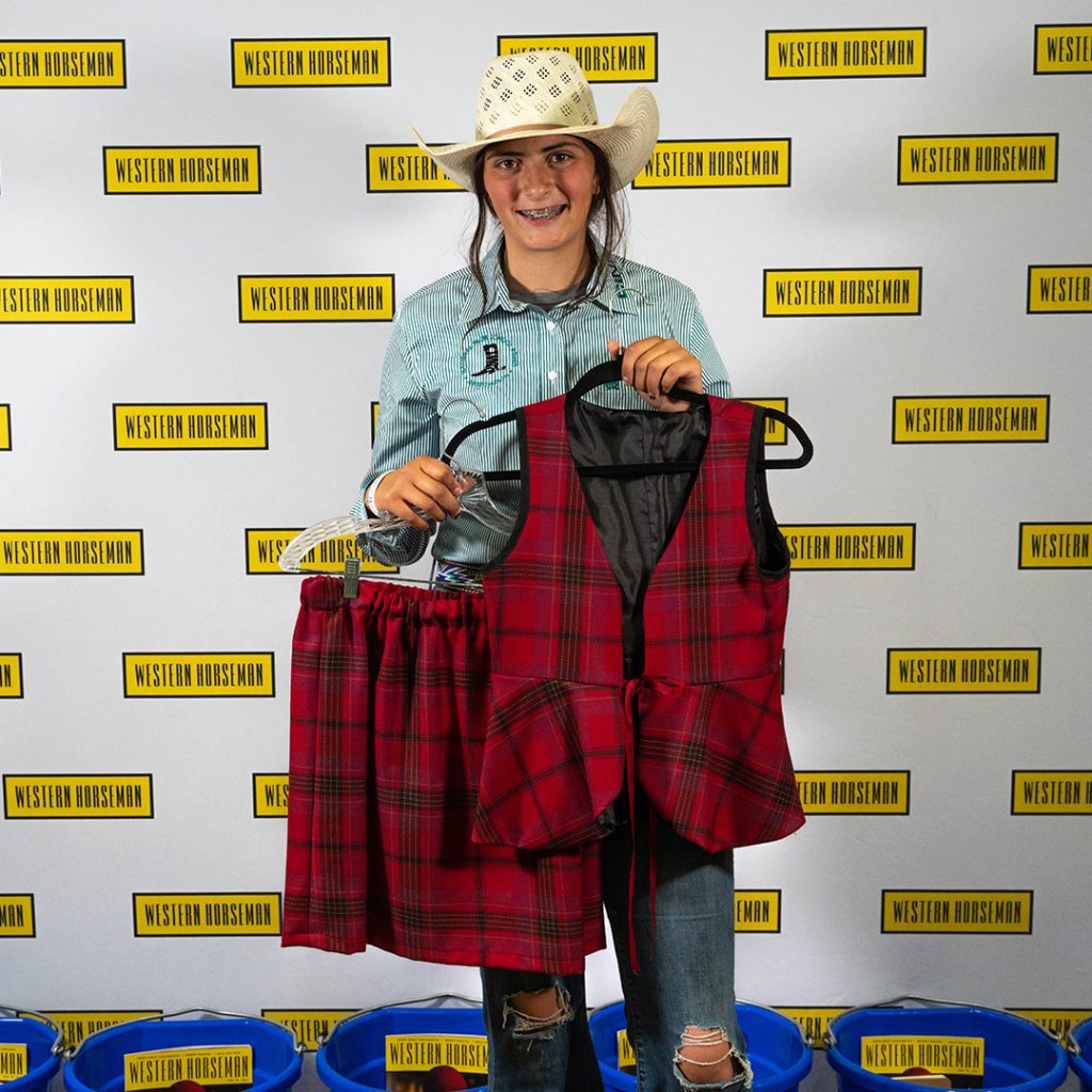Lilly Sexton holding her handmade outfit.