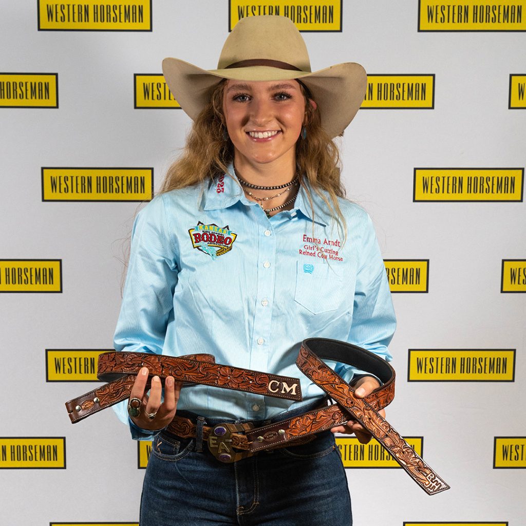 Emma Ardnt holding her tooled belts.