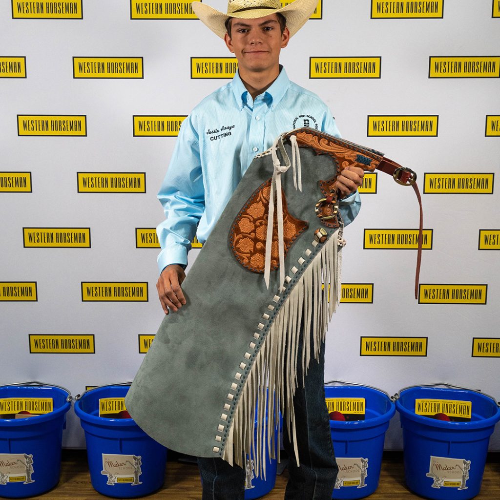 Justin Anaya holding his handmade leggings for the 2023 Western Lifestyle Trade Craft Showcase.