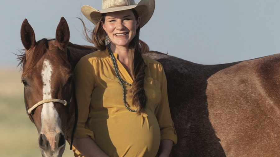 Kara Smith stands with a horse.