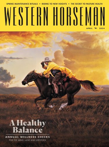 A man in a yellow coat riding a horse on the cover of the Western Horseman magazine.