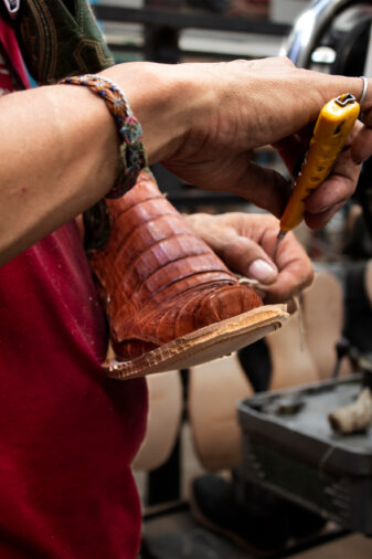 Bootmaker putting the finishing touches on a Resistol boot