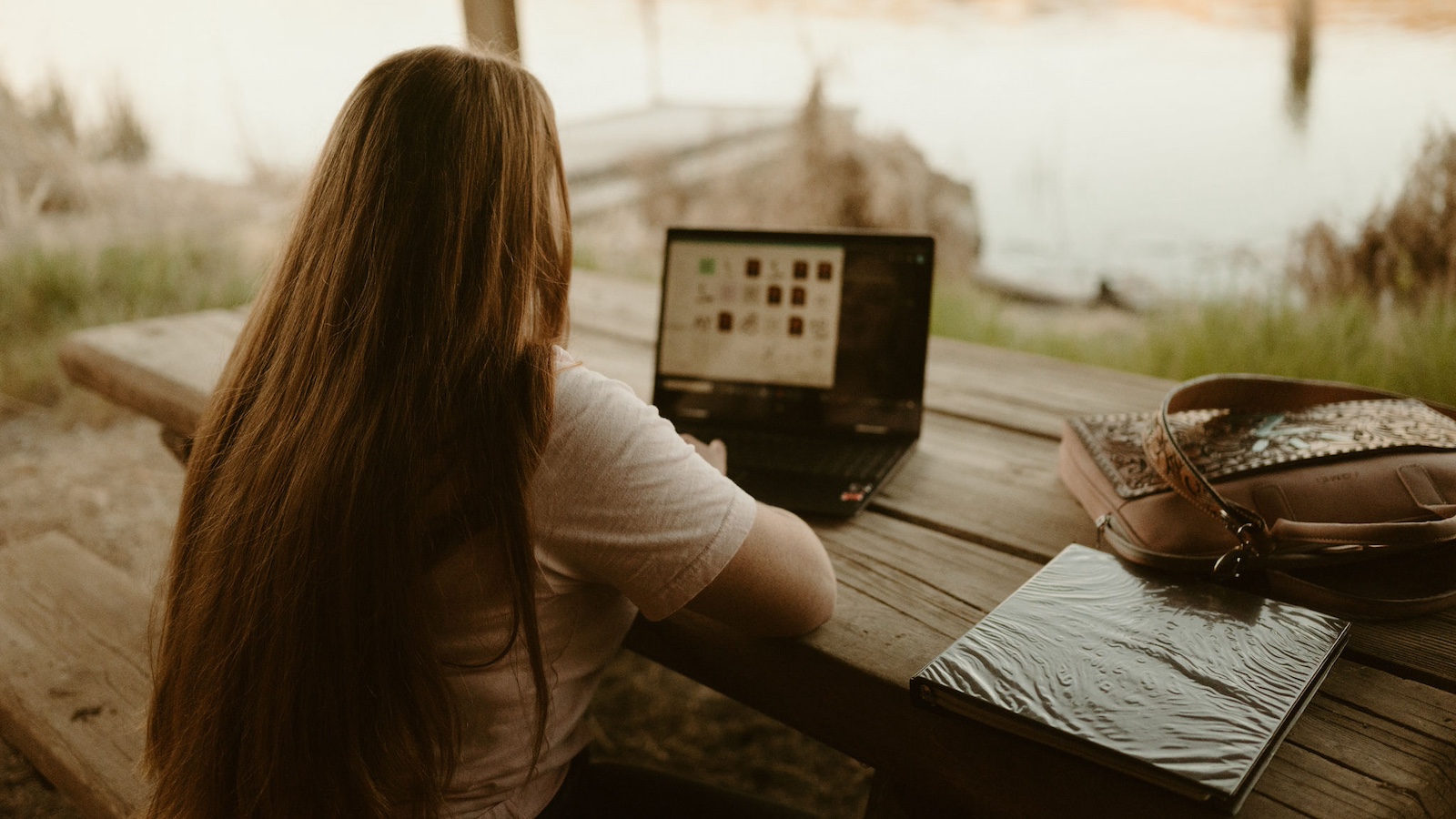 Kate Biagi working on her laptop. Photo by @oneshotshae