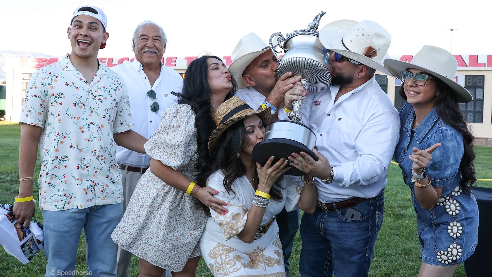 Olivarez family kissing the trophy after winning the All American Futurity. Photo by Coady Media (623) 203-4084