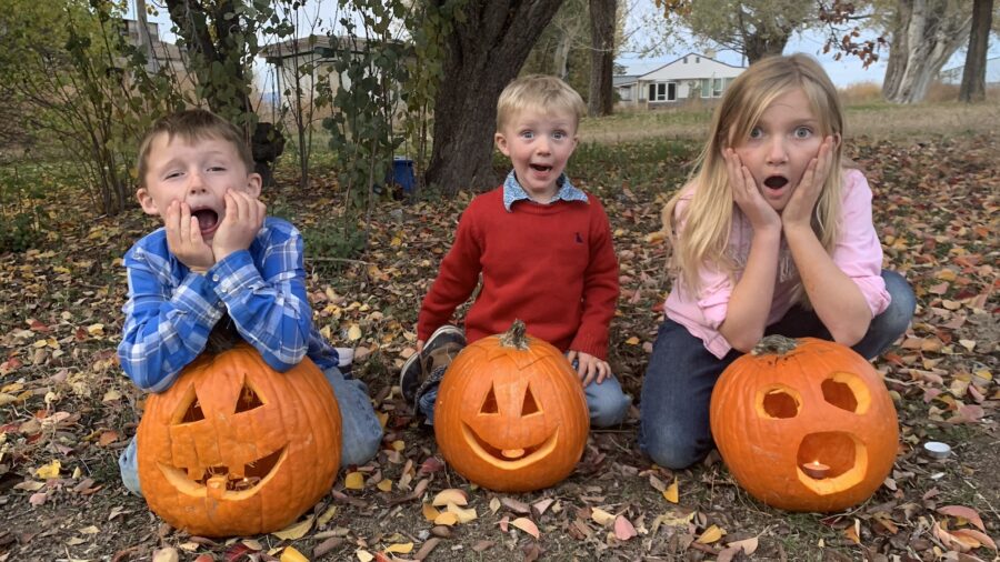 Jolyn Young's three kids with carved pumpkins