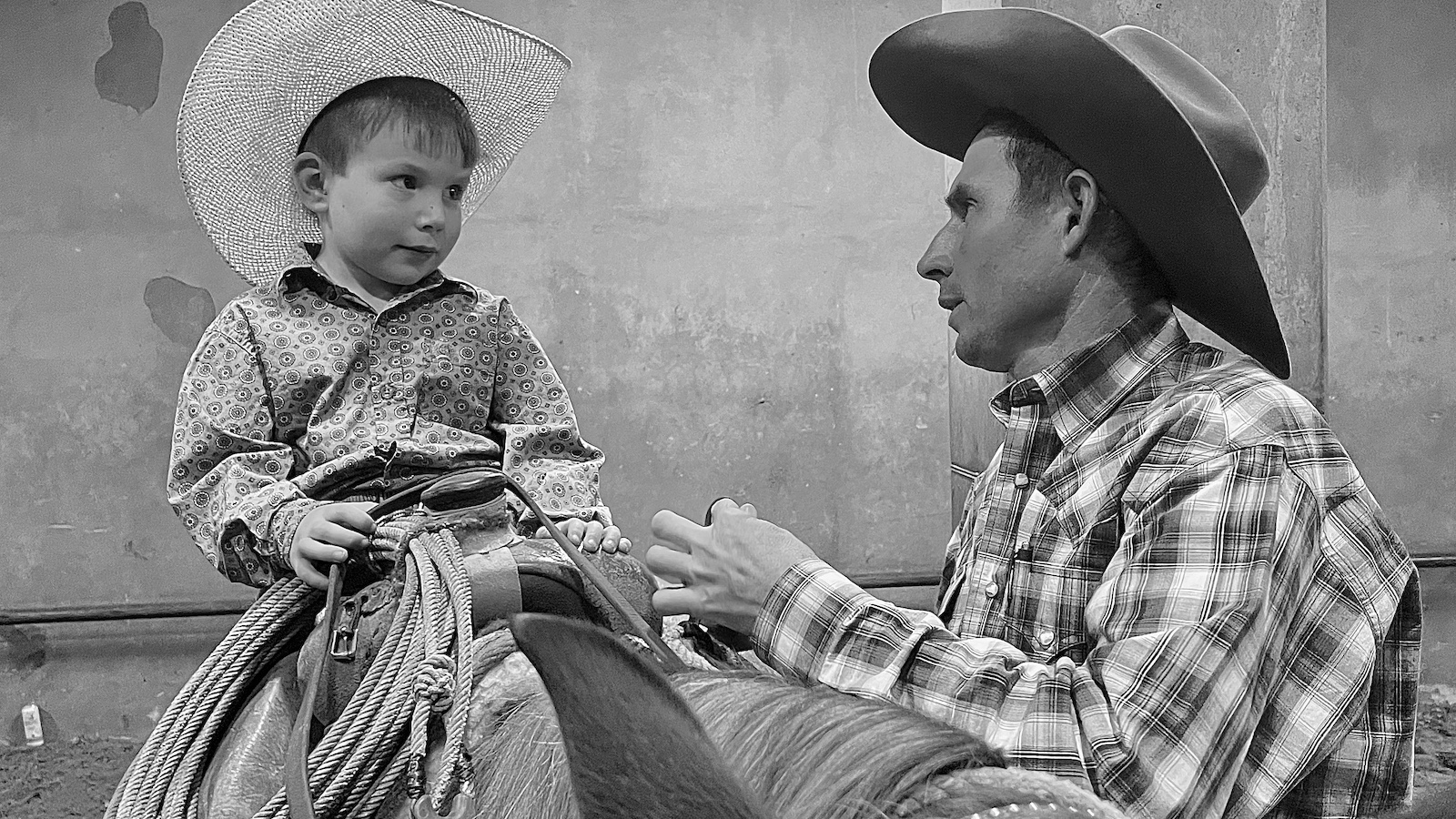 father talking to his son on a horse. Photo courtesy of Kelli Neubert