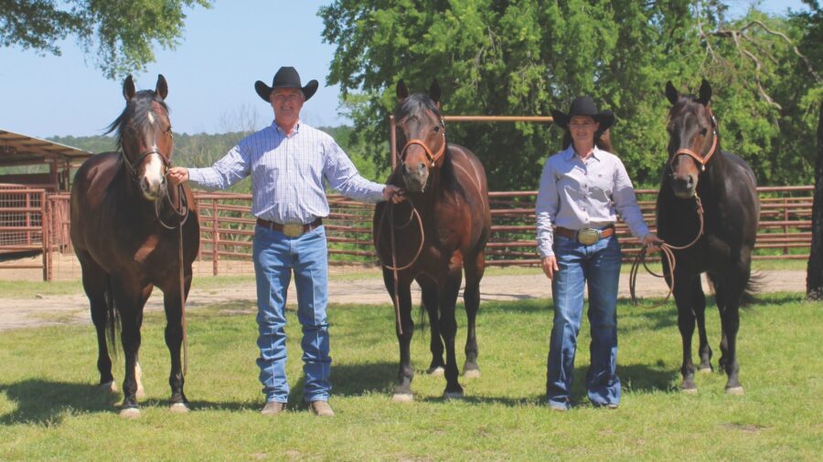 Husband and wife standing with three horses