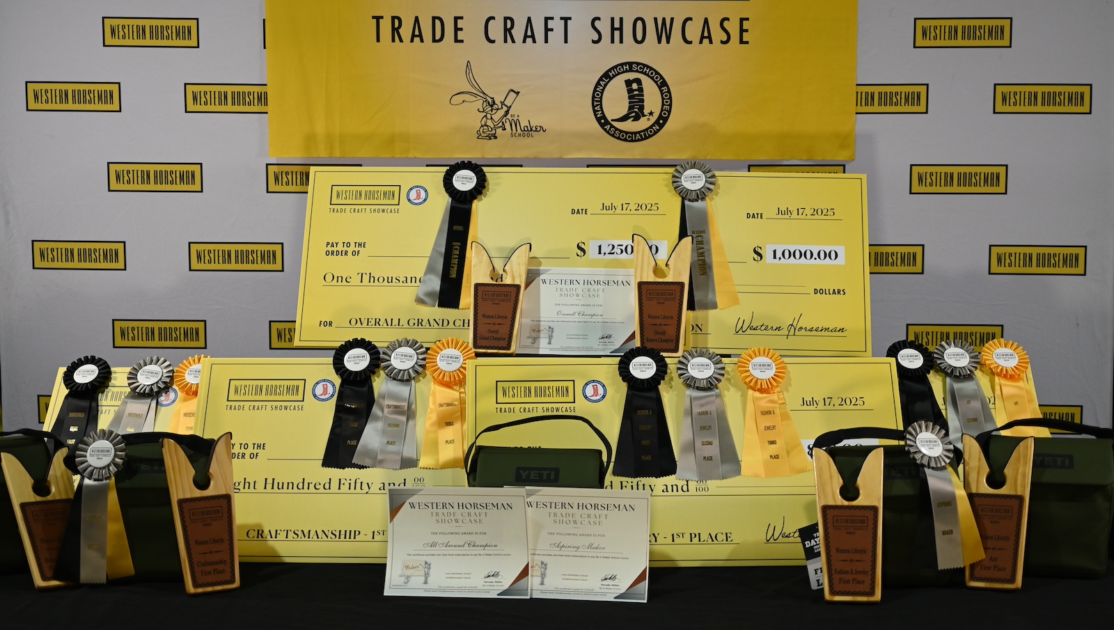 Awards for the 2025 Western Horseman Trade Craft Showcase including checks, boot jacks, YETI lunchboxes, ribbons and certificates