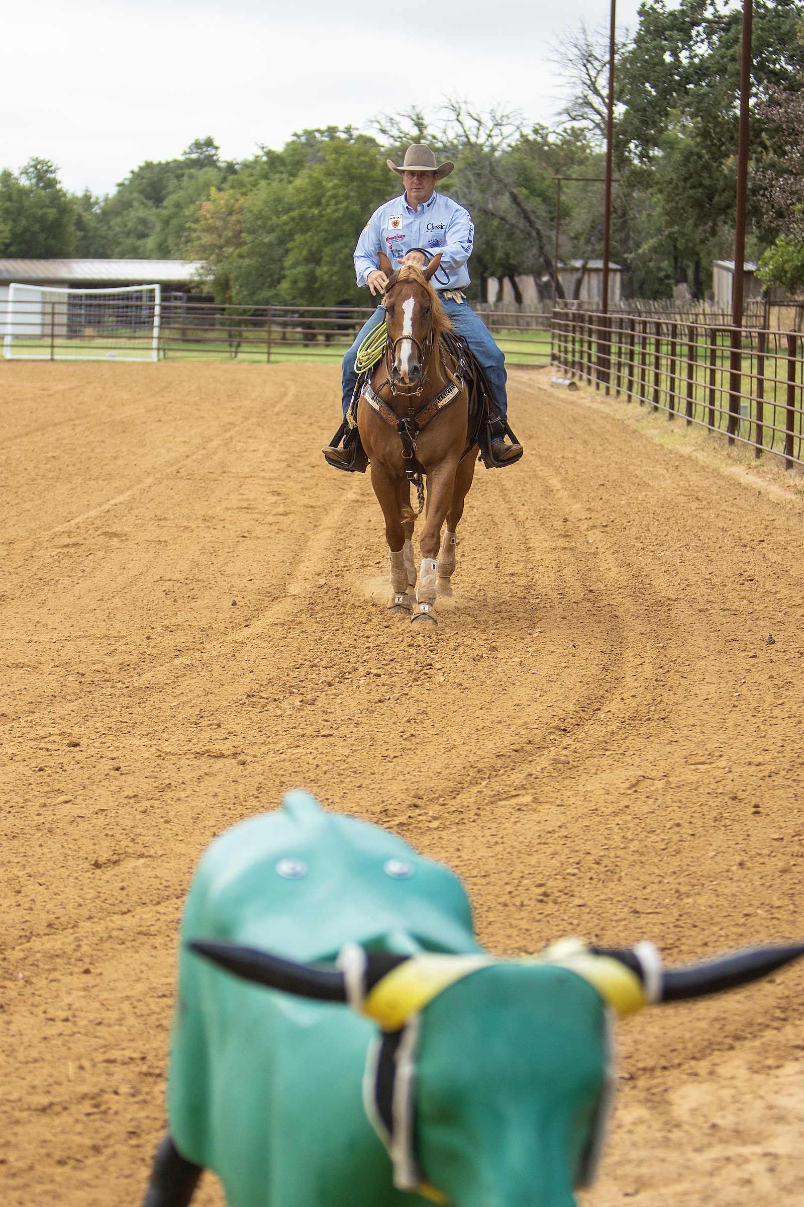 When riding in a straight line during warmup, point your hand and horse directly at an object ahead, whether it be a pole, roping dummy or other visible object.
